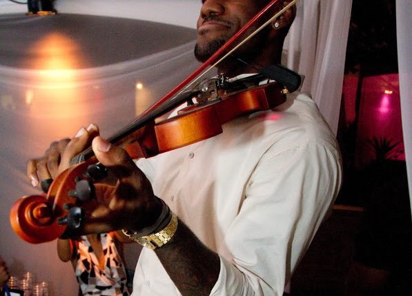 LeBron and Chris playing violin and singing.