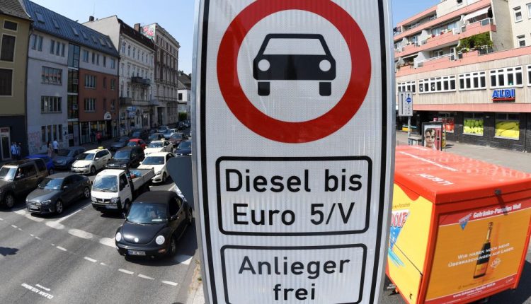 A truck passes by a traffic sign, which bans diesel cars at the Max-Brauer Allee in downtown Hamburg
